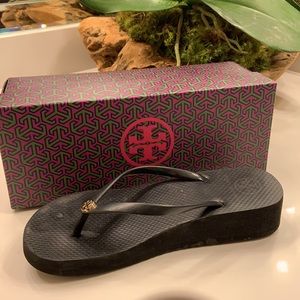 Black Tory Burch flip-flops with wedge. Difficult to find as they sell out fast!